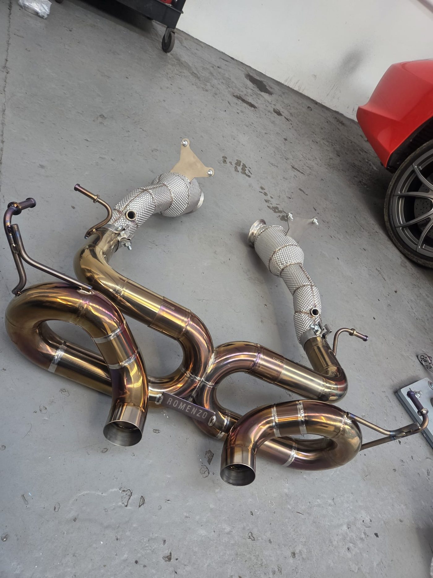 Romenzo titanium valved exhaust system laid out in the workshop
